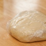 Dough covered in cling film resting