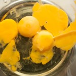 Oil and eggs in a glass bowl