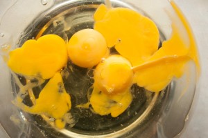 Oil and eggs in a glass bowl