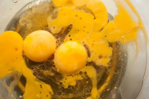 Oil, eggs, and honey in a glass bowl