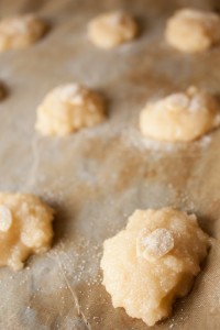 Dollops of Almond Macaroon Cookie mix on a non stick baking sheet before baking.