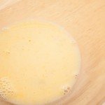 Eggs and lemon juice mix for making lemon curd in a glass bowl