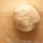 Bread dough for making bath buns after kneading. The dough is in a bowl ready for the first rising.