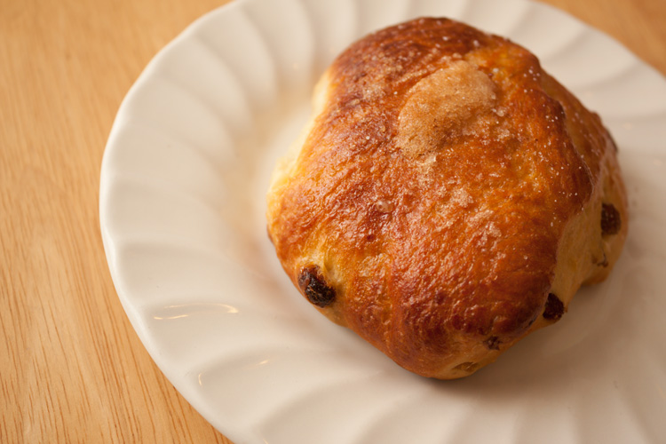 A Bath Bun on a white plate.