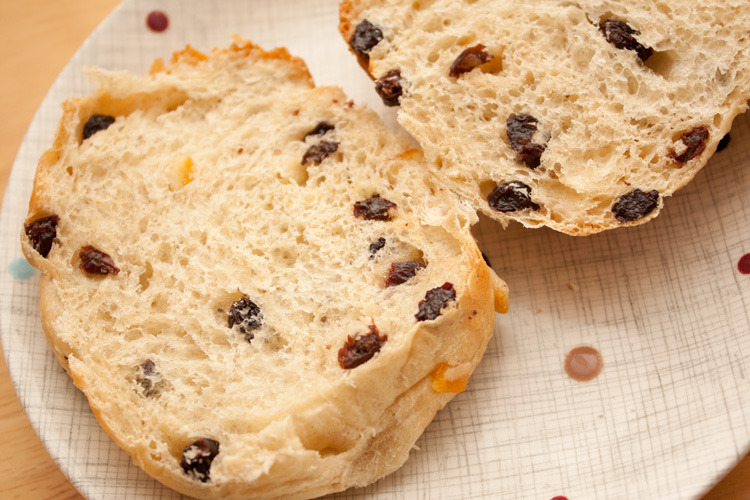 A Yorkshire teacake cut in half on a plate.