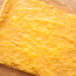 Home-made lemon curd spread on swiss roll sponge