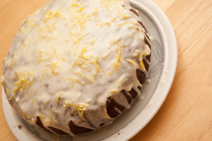 Iced Date and Walnut Cake with the icing added. Note that I used the zest of a whole lemon, so your cake should not have quite so much zest on top.